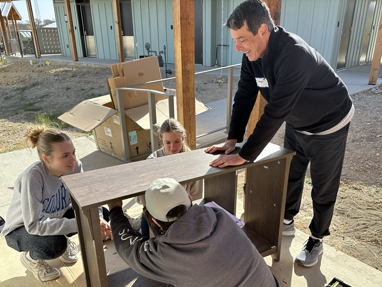 Volunteers assembling furniture at Community First! Village in Austin
