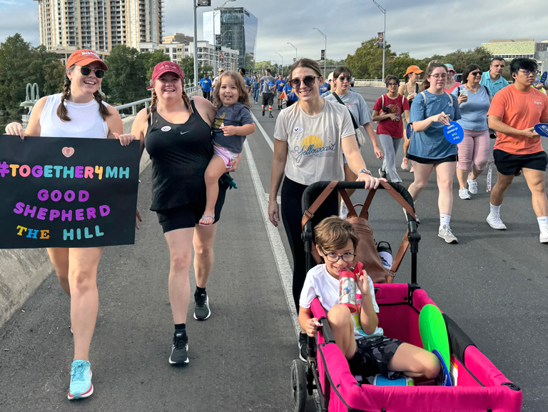 Good Shepherd Episcopal Church members walking in Austin community mental health awareness walk with families and children