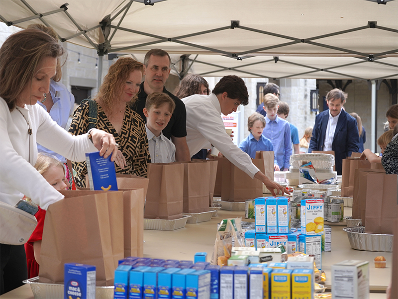 Volunteers packing Thanksgiving meal bags for families in need at Good Shepherd Episcopal Church in Austin Texas