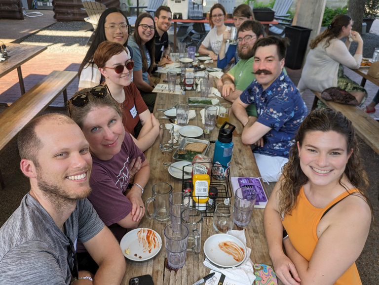 Good Shepherd Episcopal young adults gathering at outdoor table in Austin Texas for fellowship meal