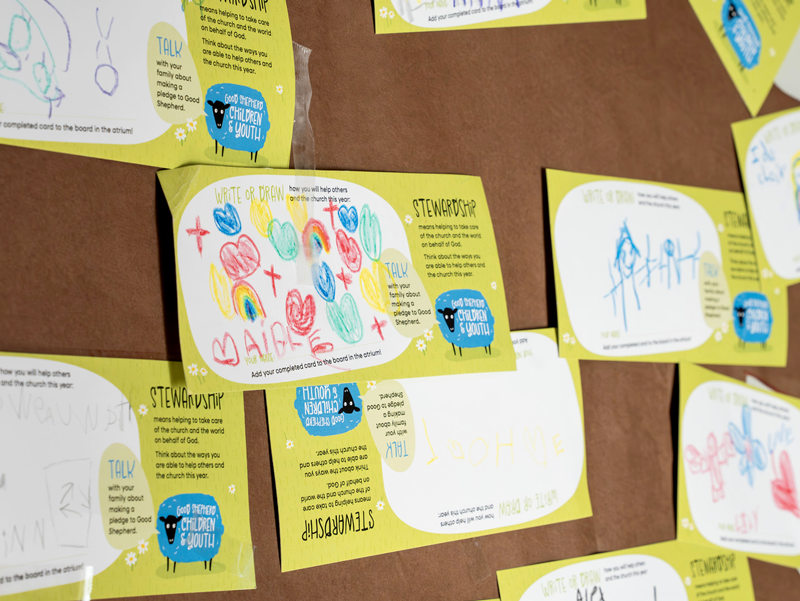 Children's stewardship pledge cards displayed on a bulletin board at Good Shepherd Episcopal Church in Austin, Texas.