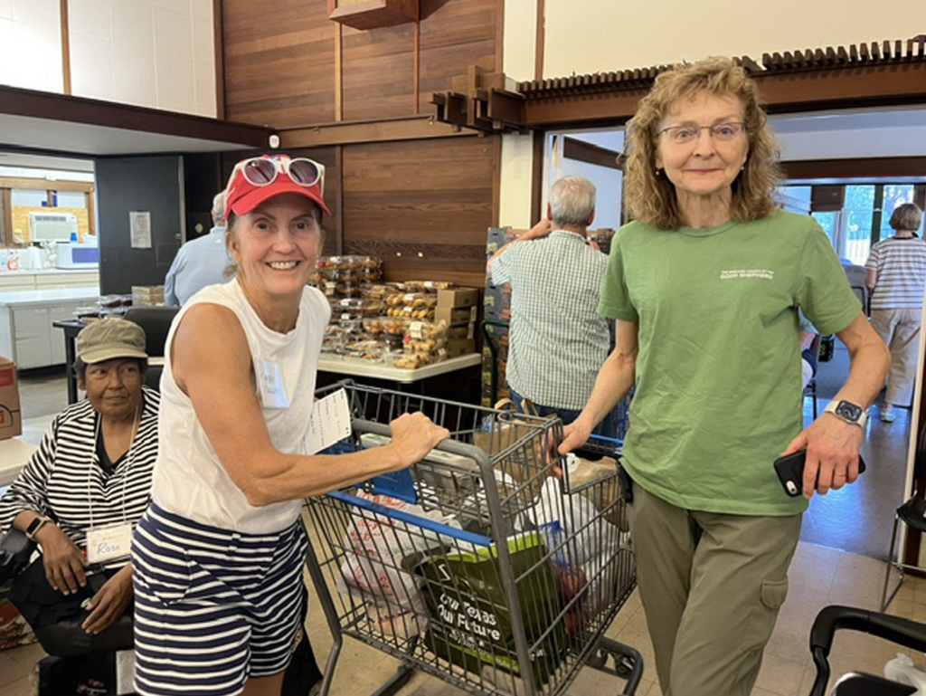 Volunteers with shopping carts distribute groceries at the Bread for All Food Pantry in Austin, Texas.
